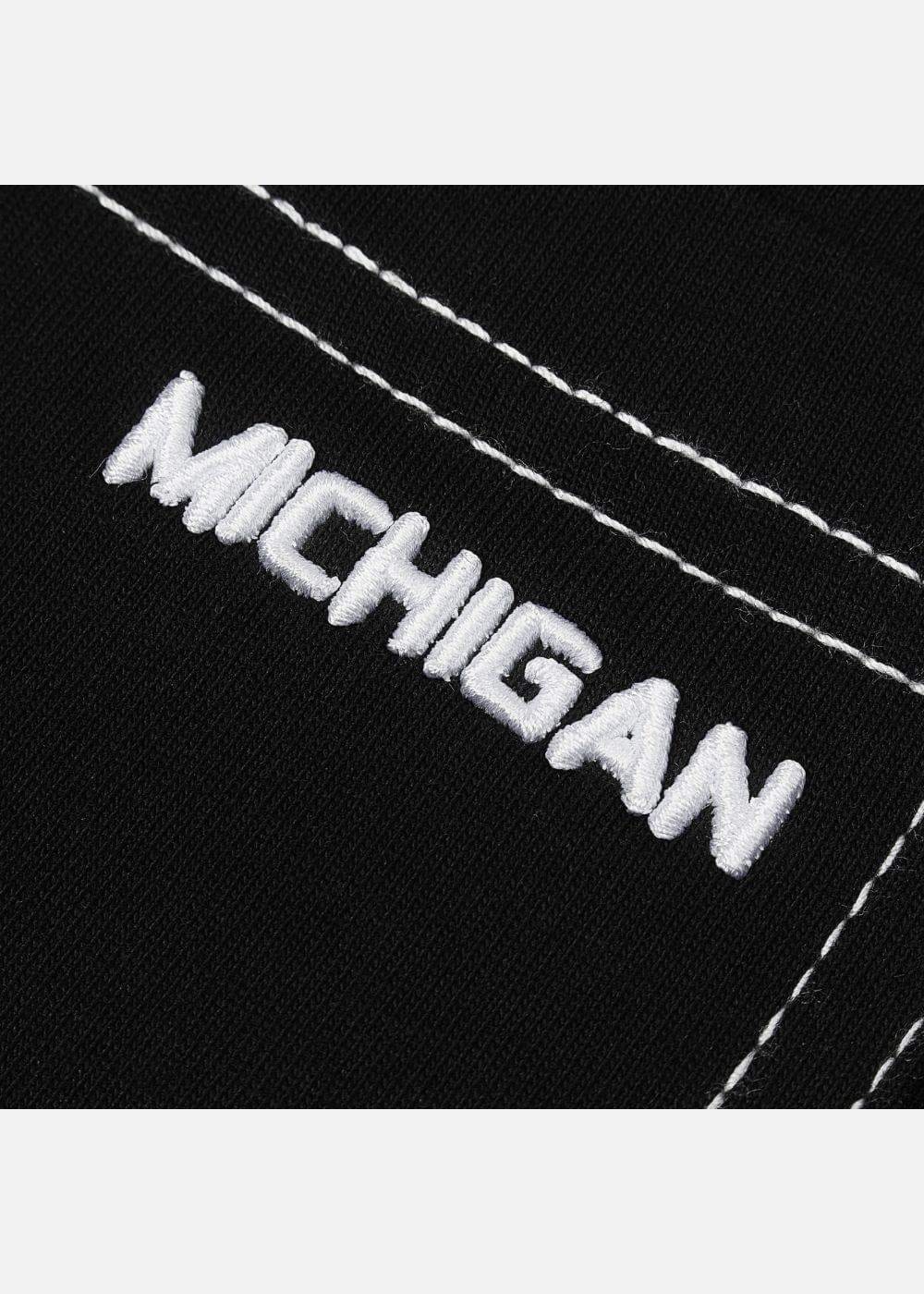 Chi tiết thêu chữ MICHIGAN trắng trên vải đen, đường chỉ nổi bật, thiết kế thời trang nam